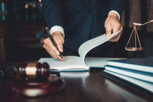 photo of a man signing documents for bail