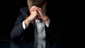 stressed man on hand cuffs